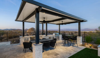 Outdoor kitchen with BBQ, patio cover, and turf