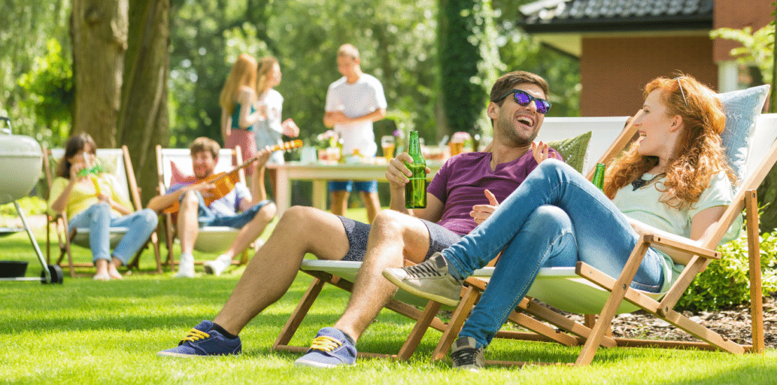 People sitting on lawn chairs talking to each other