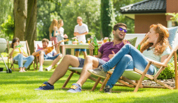 People sitting on lawn chairs talking to each other