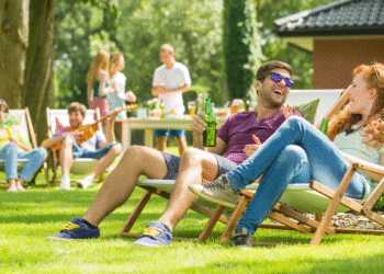 People sitting on lawn chairs talking to each other