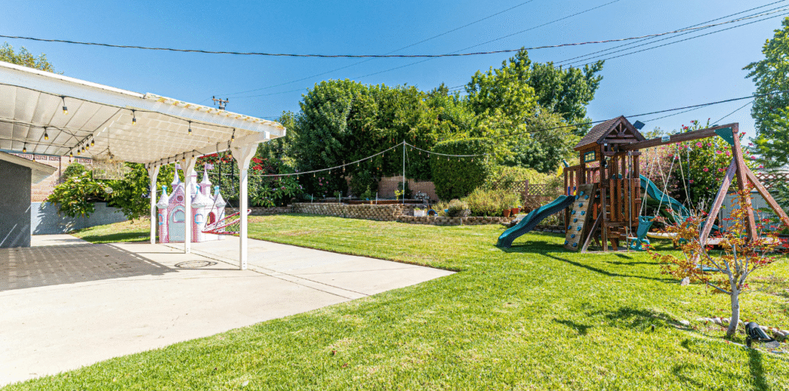 Dog-friendly backyard with artificial turf, shade, and safe landscaping in a Phoenix, AZ home